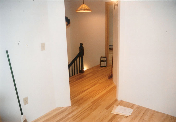 Interior walls are complete and new ash hardwood floor has been 